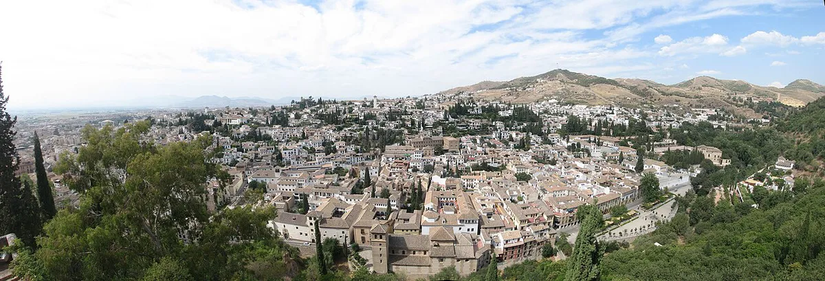 Narrow whitewashed lane in the Albaicín quarter of Granada with the Alhambra beyond — 1
