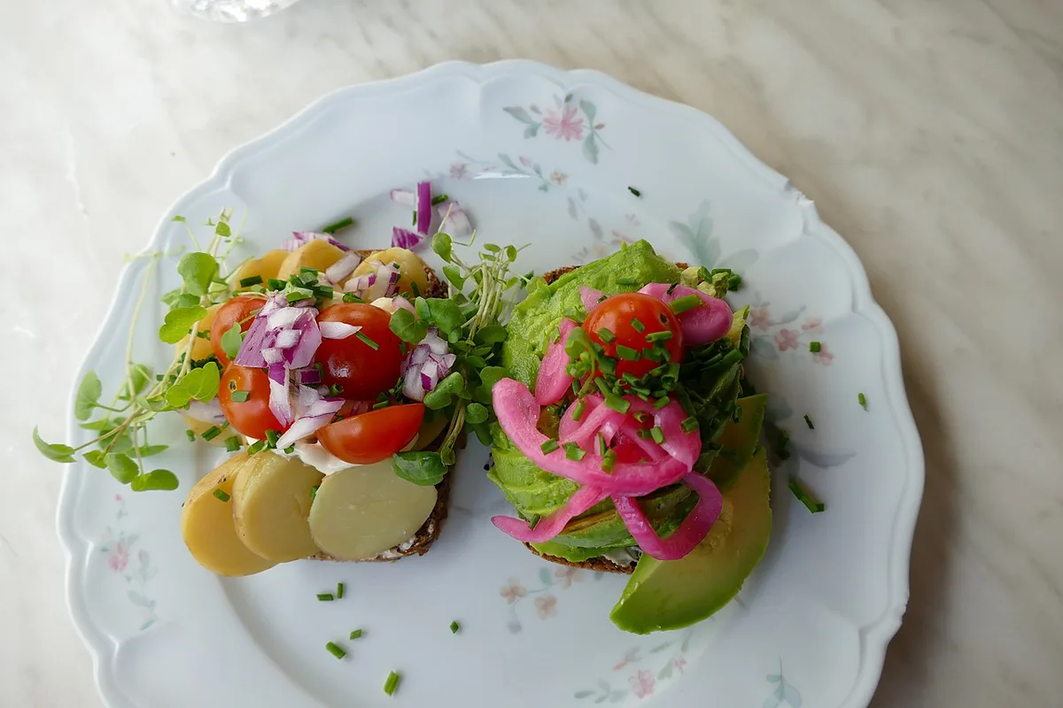 Traditional open-faced smørrebrød sandwiches served at a market stall in Torvehallerne, Copenhagen — 1