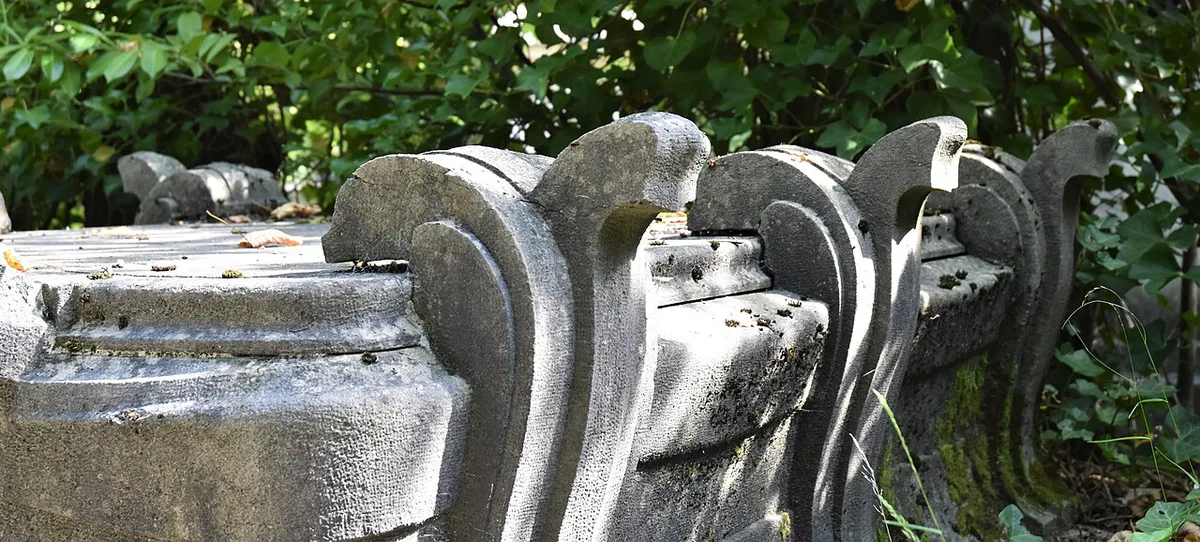 Ivy-covered Art Nouveau gravestones under trees at the Cimetière du Dieweg in Uccle, Brussels — 2