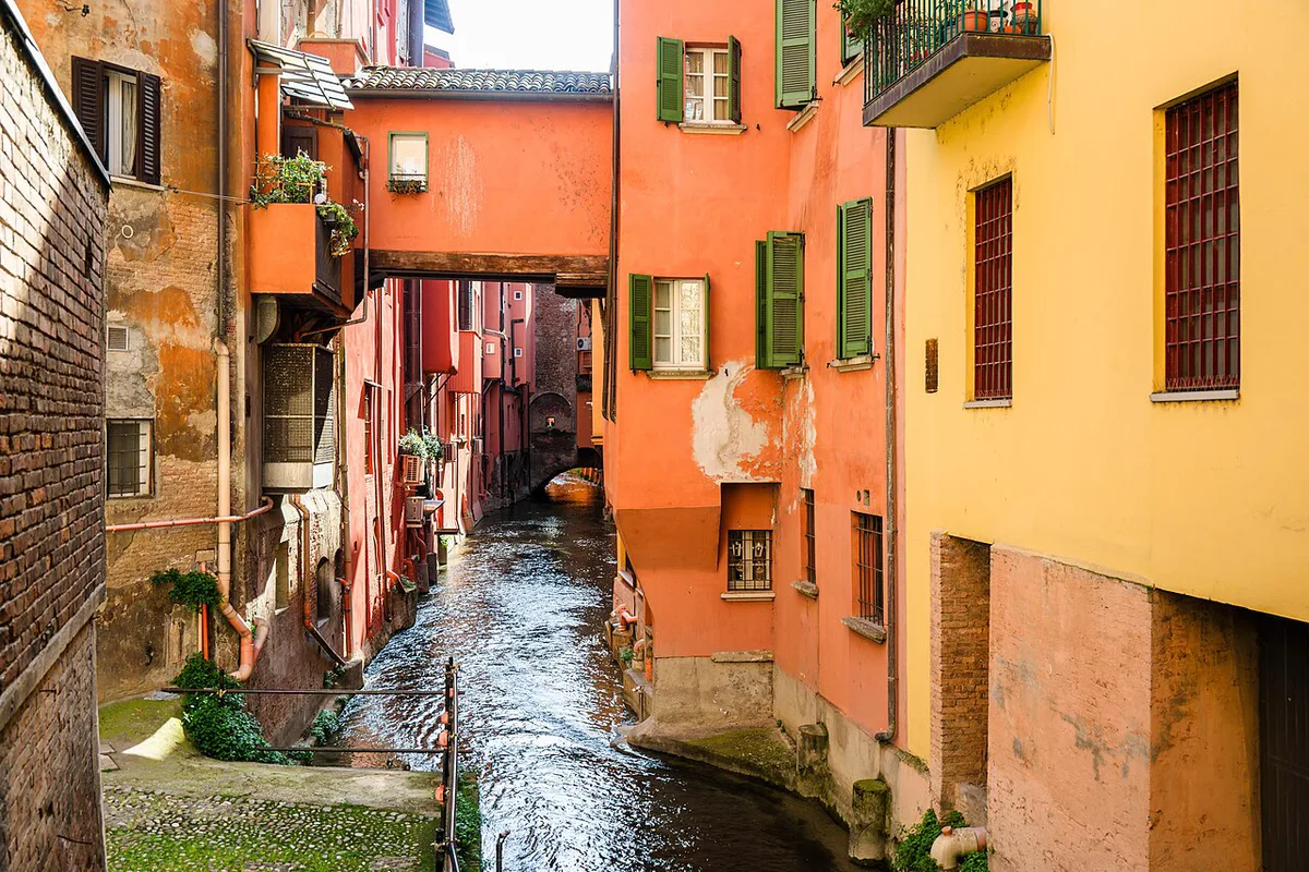 Colourful canal-side buildings reflected in the Canale delle Moline seen through the Finestrella di Via Piella in Bologna — 1