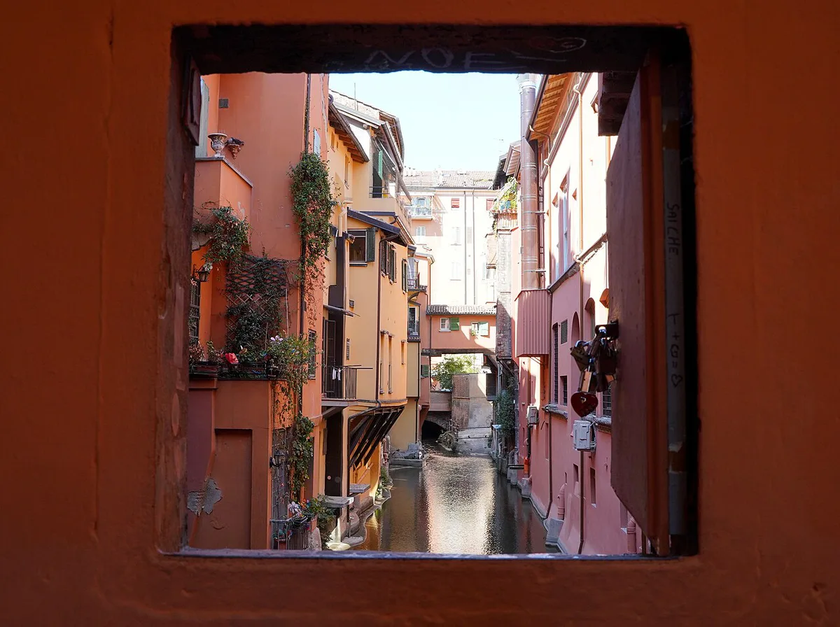 Colourful canal-side buildings reflected in the Canale delle Moline seen through the Finestrella di Via Piella in Bologna — 2
