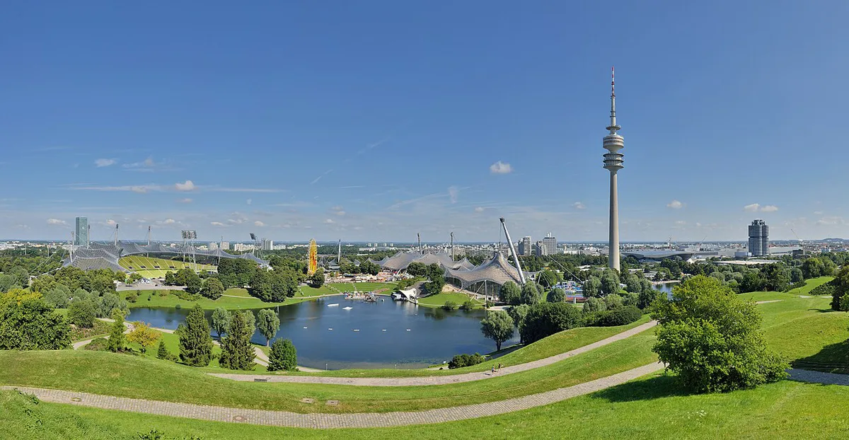 People relaxing on the lawns of the Englischer Garten with the Monopteros temple in Munich — 1