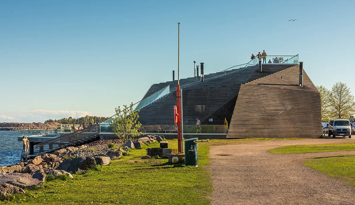 Wood-heated sauna stove and benches inside Kotiharjun Sauna in Helsinki — 1