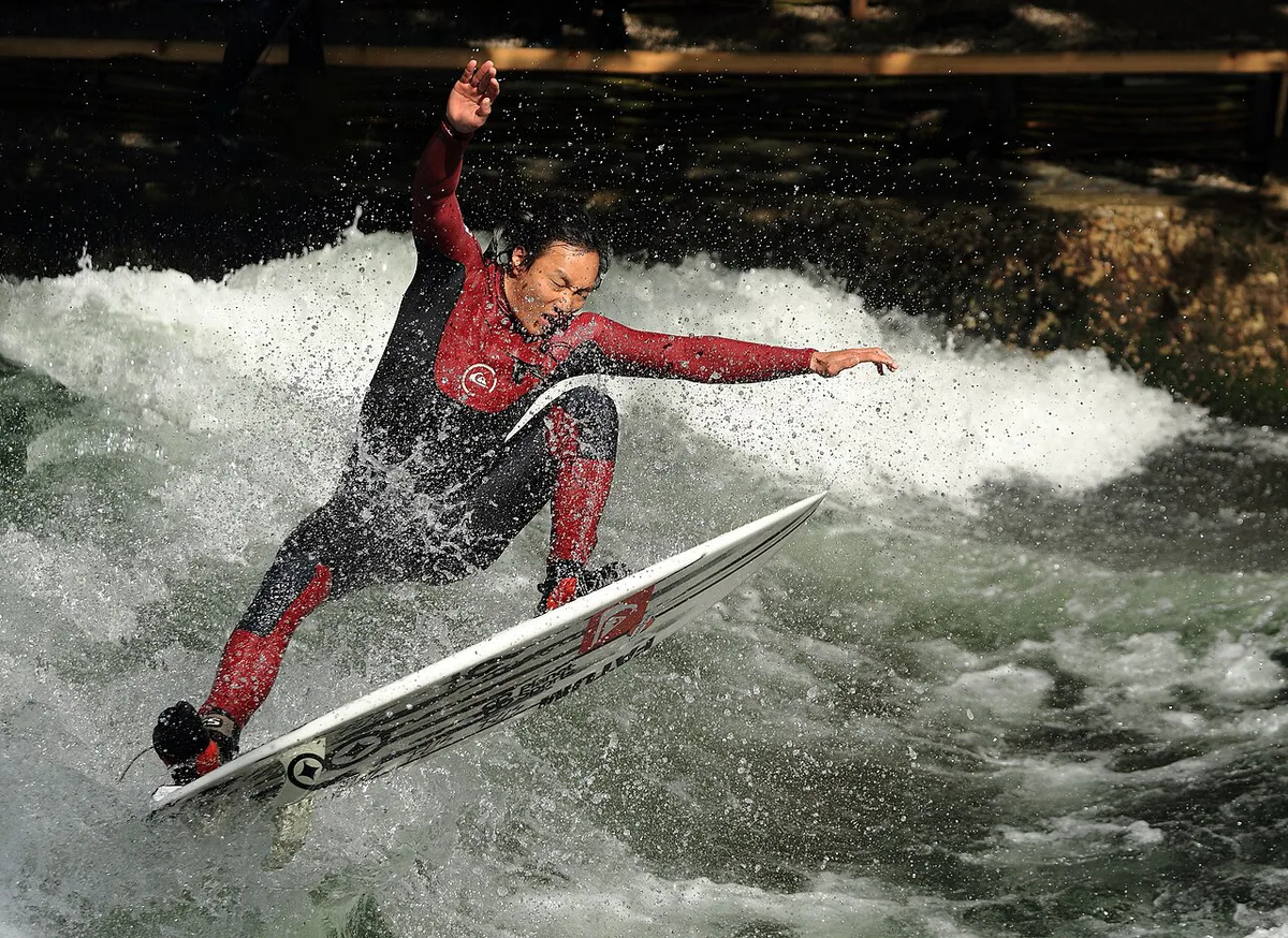 Surfers riding the Eisbach standing wave beside the Englischer Garten in Munich — 2