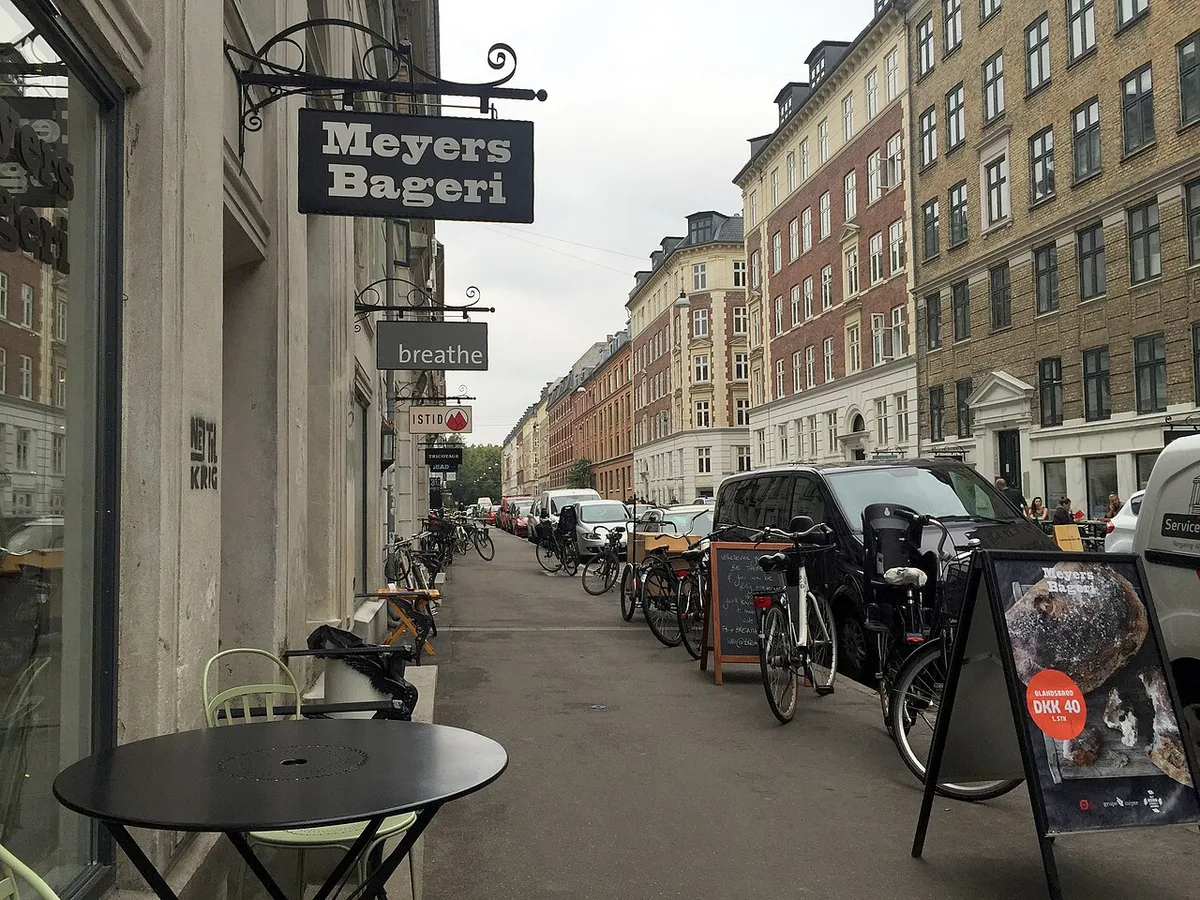 Cyclists riding along the Amager waterfront path near CopenHill in Copenhagen — 2