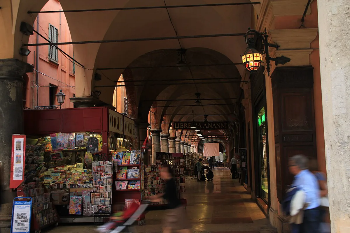 Rows of covered stone porticoes lining a historic street in central Bologna — 2