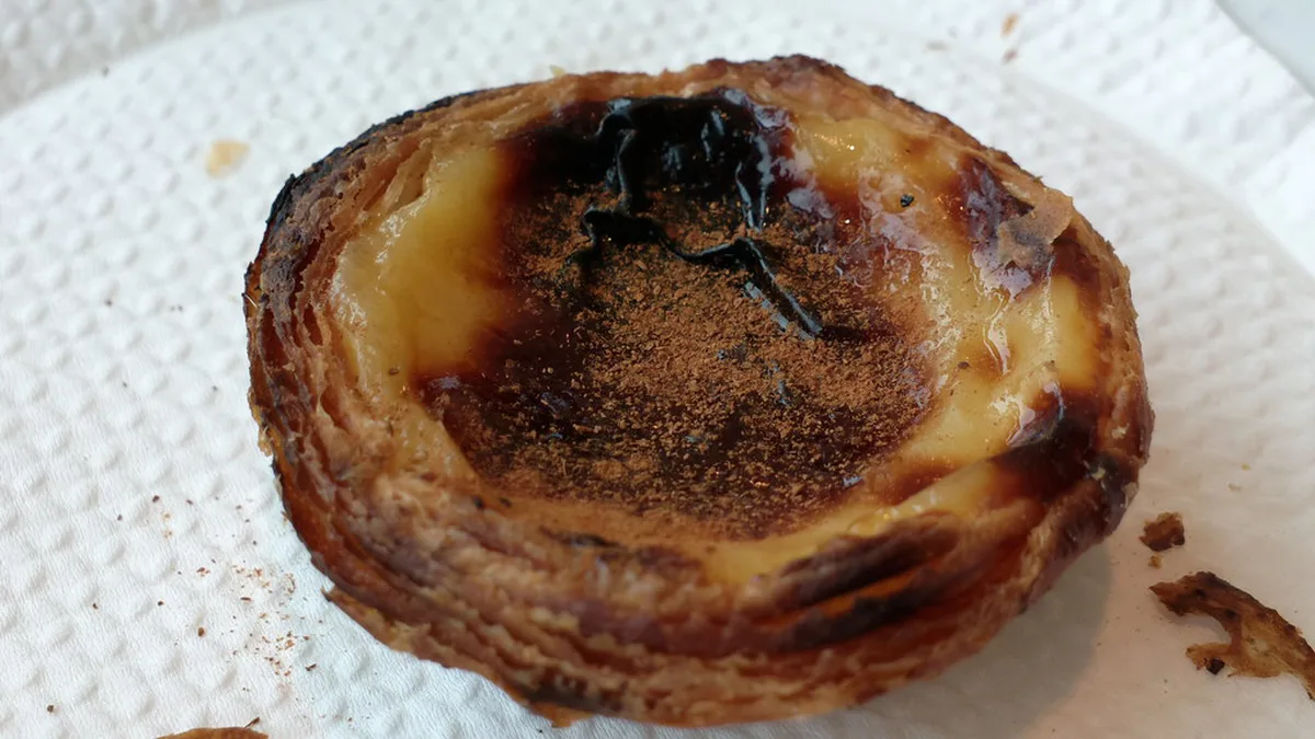 Pastel de nata with cinnamon dusting, iconic Portuguese custard tart from Porto