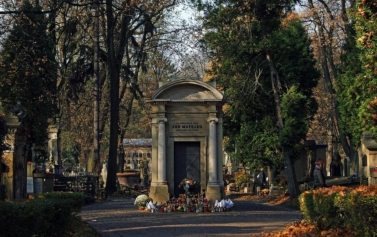 Candlelit Art Nouveau tombstones at Rakowicki Cemetery in Kraków — 1