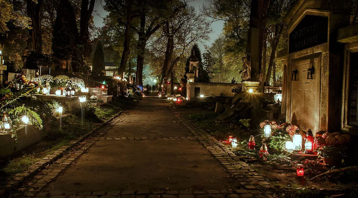 Candlelit Art Nouveau tombstones at Rakowicki Cemetery in Kraków — 2