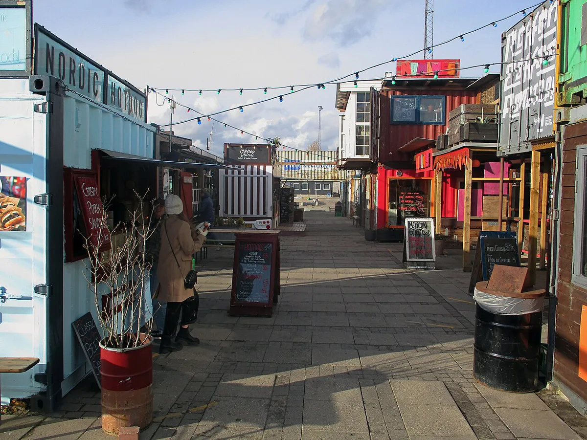 Shipping-container food stalls and waterfront seating at Reffen street food market in Copenhagen — 2